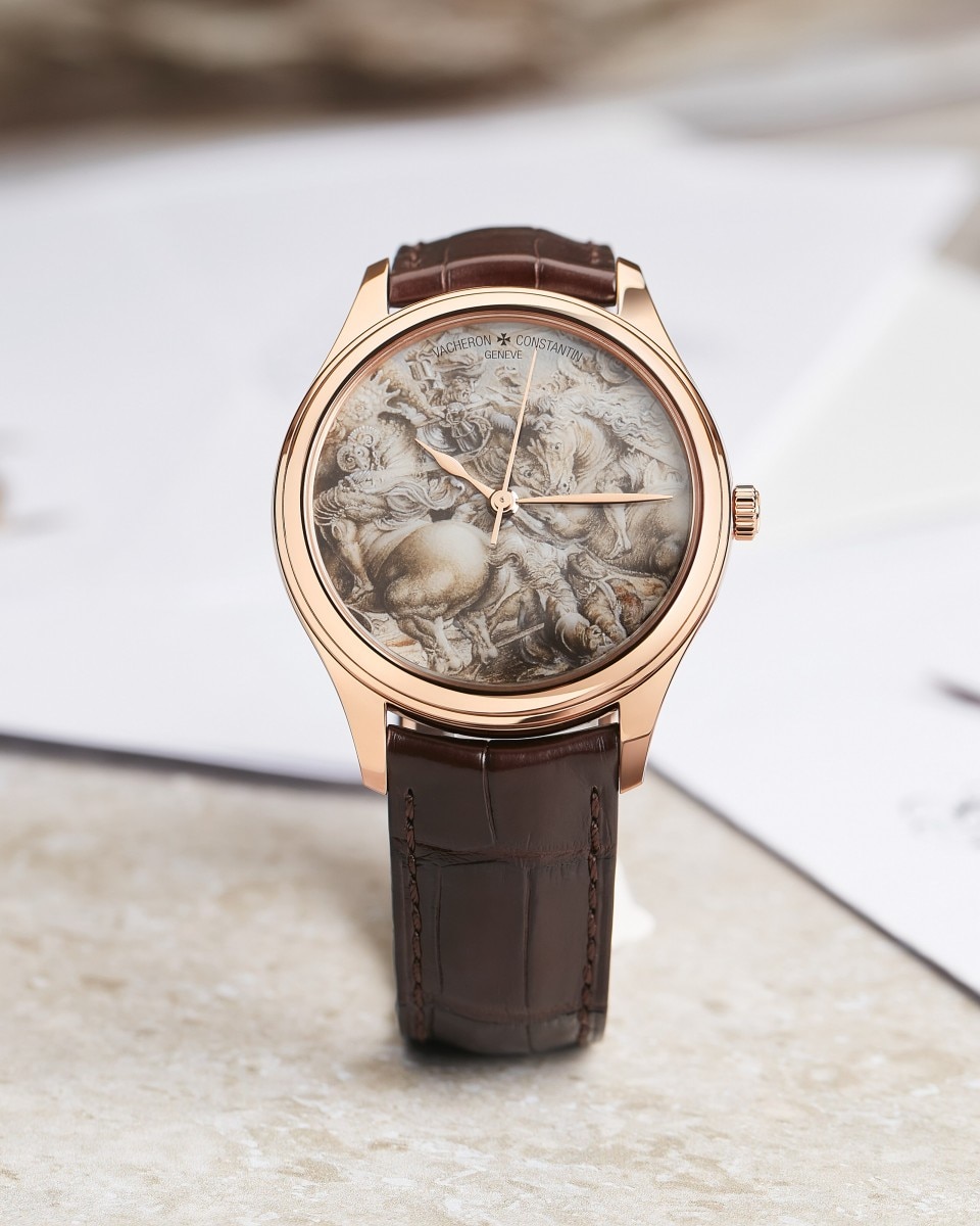 Watch with a brown leather strap and gold head and hands