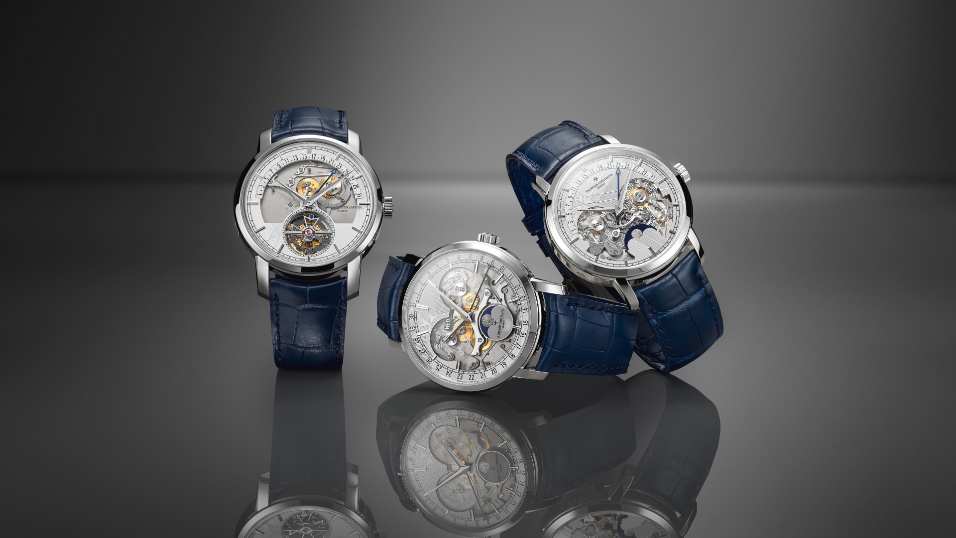 Three luxury watches with skeleton dials, intricate complications, and a blue leather straps.