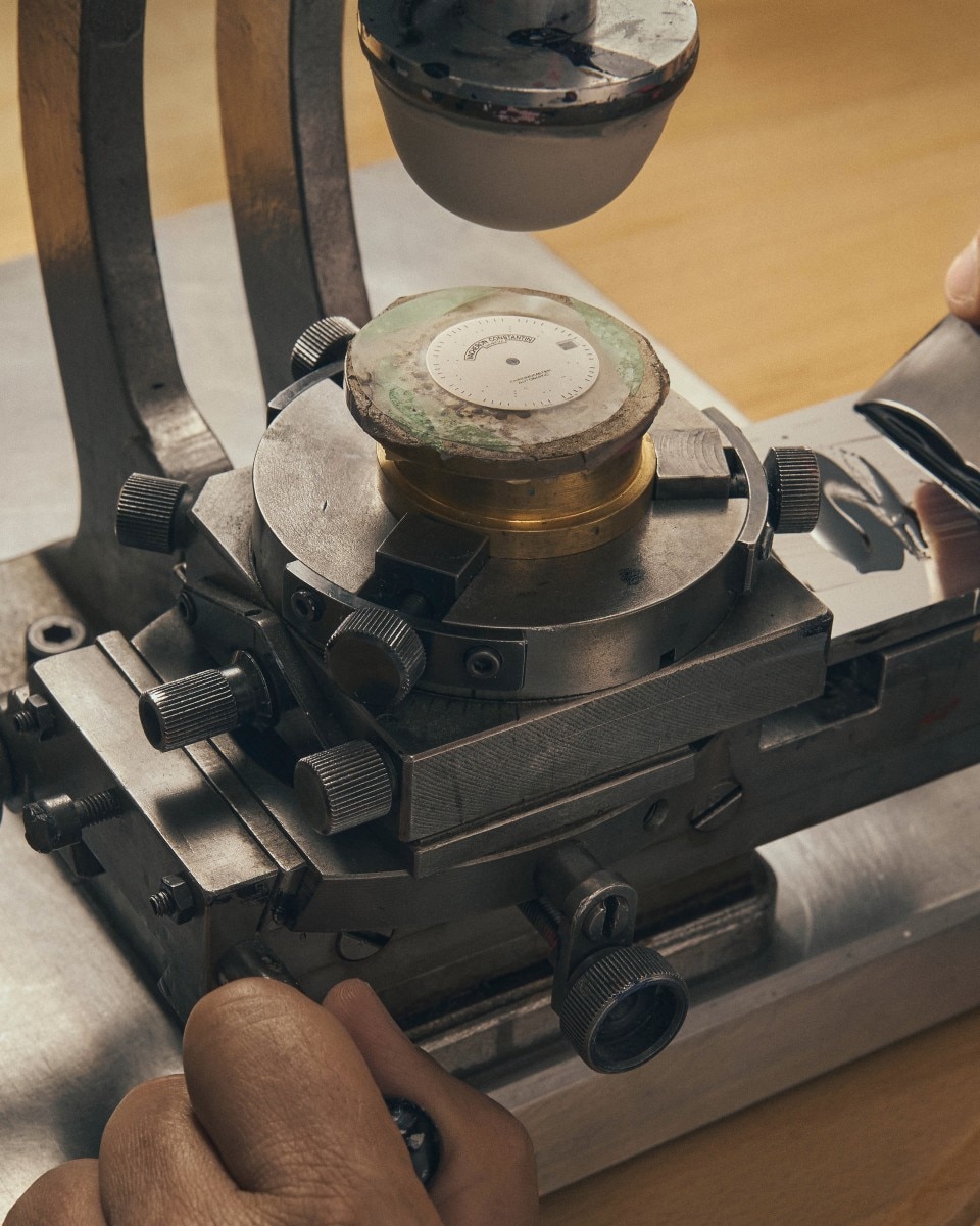 Close-up of a metal stamping machine used in watchmaking.