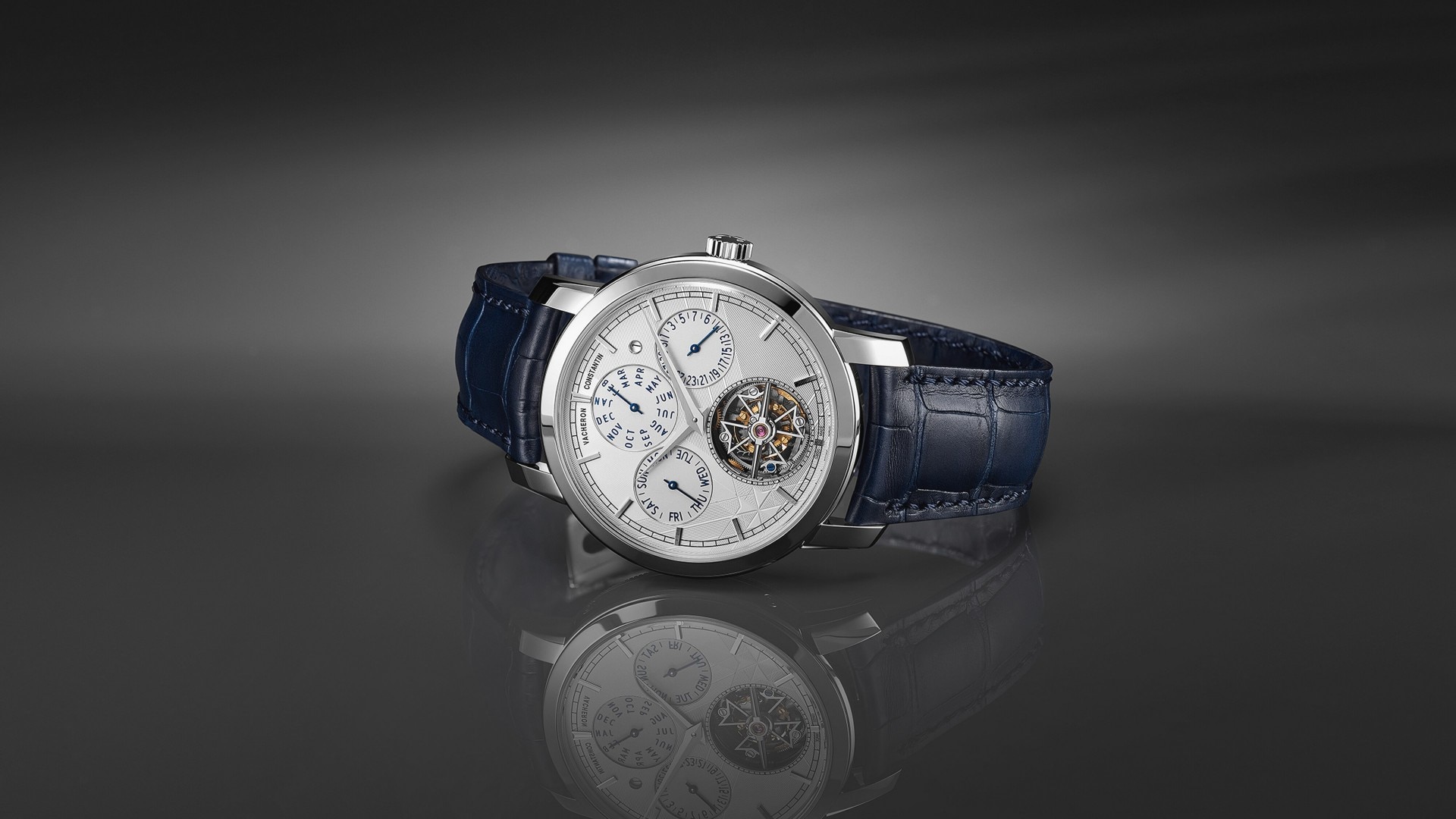 Luxury watch with a tourbillon, multiple complications, and a blue leather strap.