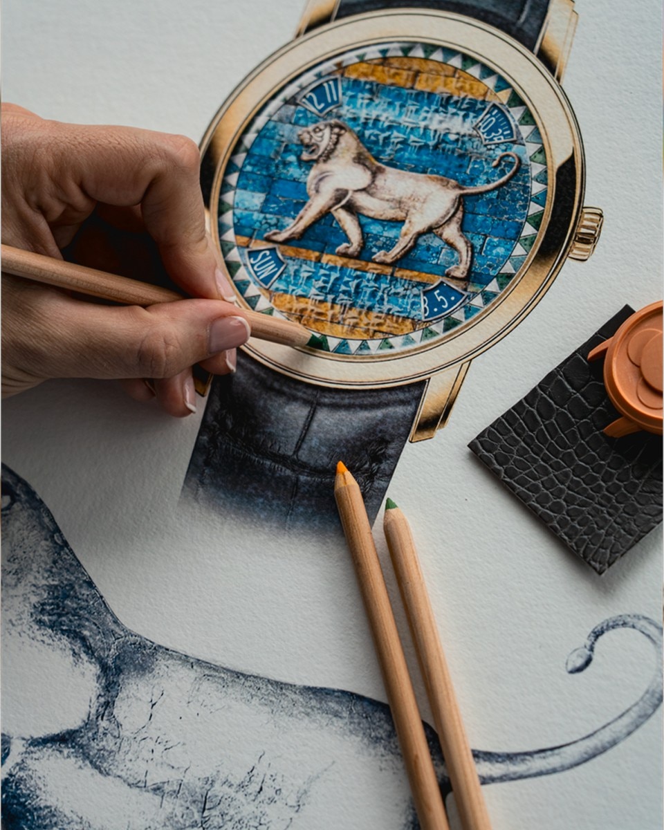 Watch with a detailed lion motif on a turquoise and gold background, next to drawing tools.